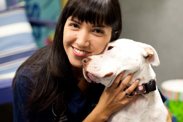 dog affectionately hugging woman